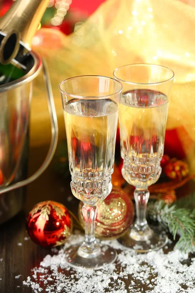 Composition with Christmas decorations and two champagne glasses, on bright background — Stock Photo, Image