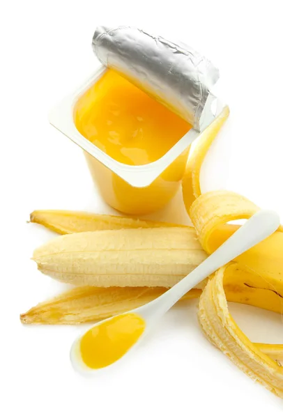 Leckeres Dessert in offenem Plastikbecher und Banane, isoliert auf weiß — Stockfoto