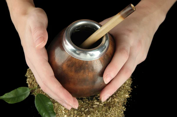 Woman hands holding calabash and bombilla with yerba mate isolated on black — Stock Photo, Image