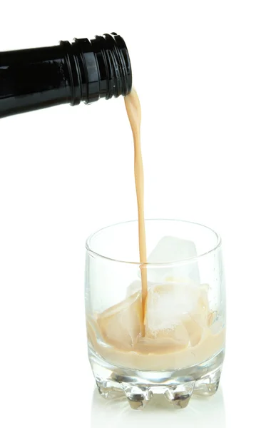 Leje się alkohol w szkło na białym tle — Zdjęcie stockowe