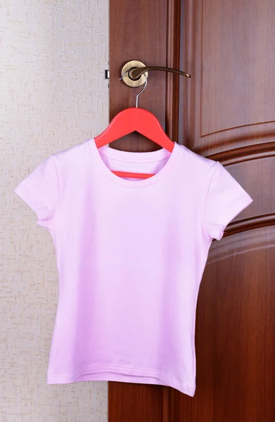 T-shirt hanging on door — Stock Photo, Image