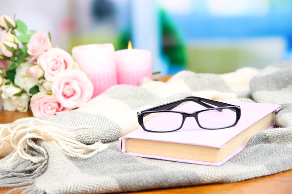 Composition with old book, eye glasses, candles, flowers and plaid — Stock Photo, Image