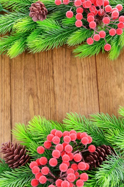 Christmas tree branches on wooden background — Stock Photo, Image