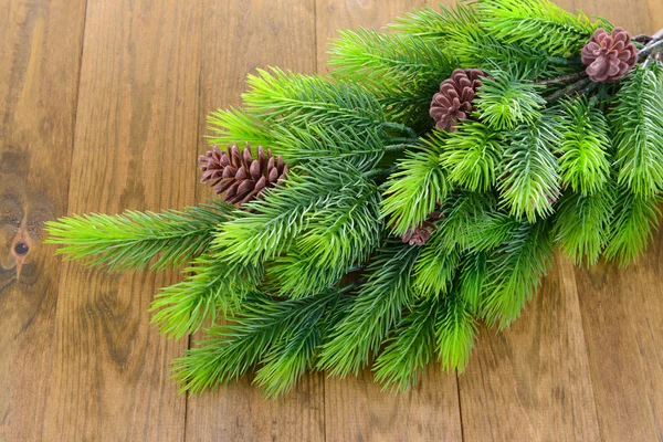 Christmas tree branch on wooden background — Stock Photo, Image