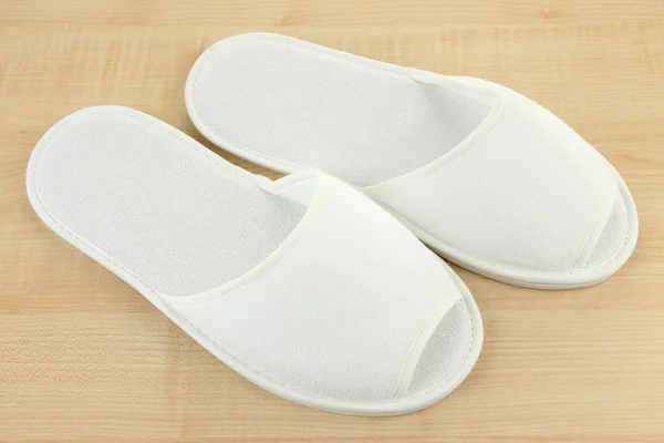 White slippers on wooden background — Stock Photo, Image