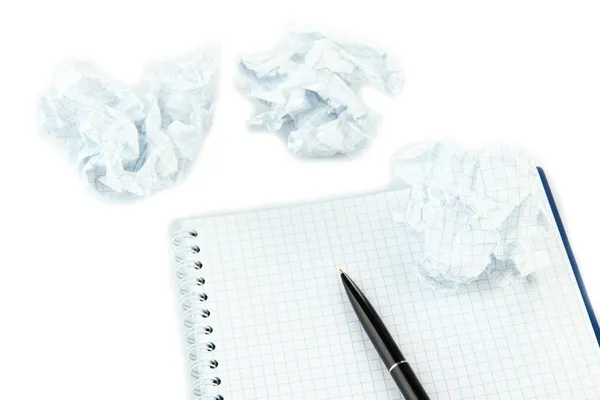 Crumpled paper balls with notebook and pen isolated on white — Stock Photo, Image