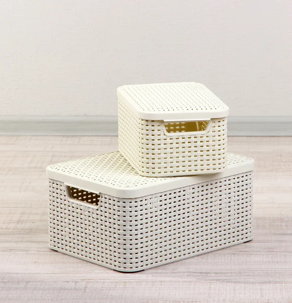Plastic baskets for storing things in floor on room background — Stock Photo, Image