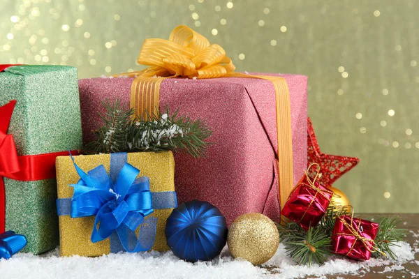 Vackra ljusa gåvor och jul inredning, mot glänsande bakgrund — Stockfoto