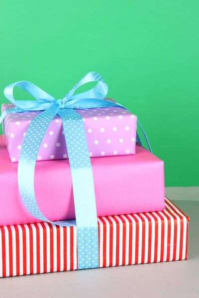 Gift box tied with a ribbon on a colored background — Stock Photo, Image