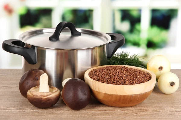 Ingredients for cooking buckwheat on table in kitchen — Stock Photo, Image