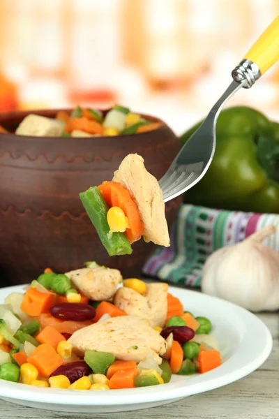 Baked mixed vegetable with chicken breast in pot, on bright background — Stock Photo, Image