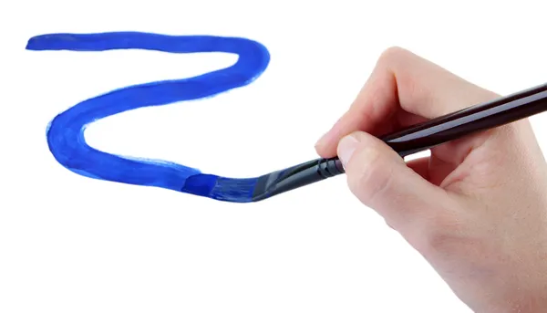 Hand holding brush with blue paint isolated on white — Stock Photo, Image