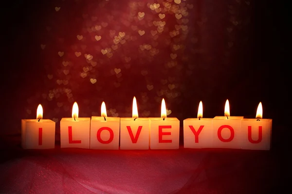 Candles with printed sign I LOVE YOU,on blur lights background — Stock Photo, Image