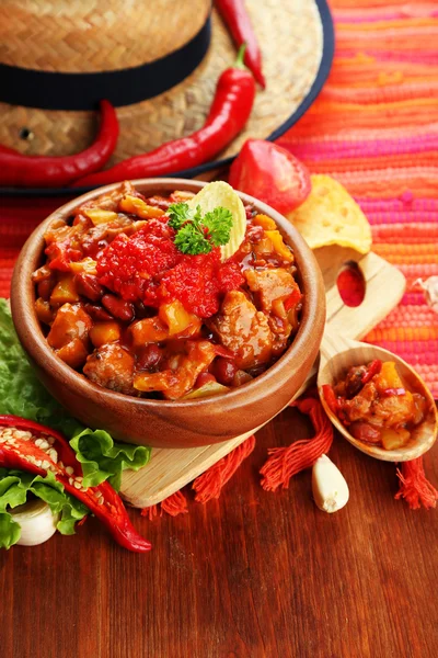 Chili Corn Carne - traditional mexican food, in wooden bowl, on napkin, on wooden background — Stock Photo, Image