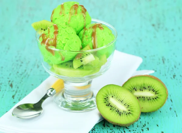 Delicious ice cream on glass vase on wooden table close-up — Stock Photo, Image