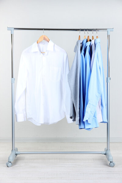 Office male clothes on hangers, on gray background