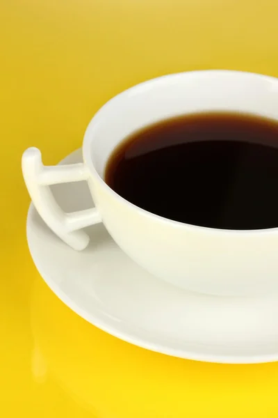 A cup of strong coffee on yellow background — Stock Photo, Image