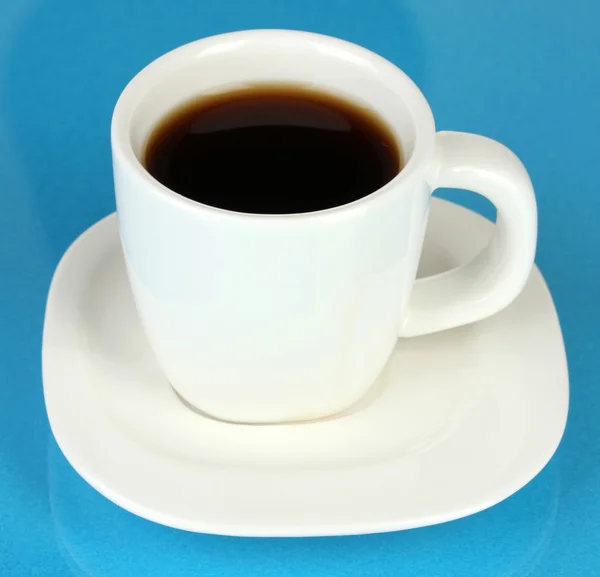 A cup of strong coffee on blue background — Stock Photo, Image