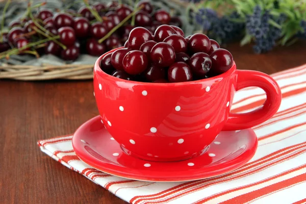 Сладкая вишня в чашке на столе крупным планом — стоковое фото