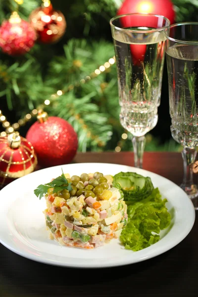 Russian traditional salad Olivier, on wooden table, on bright background — Stock Photo, Image