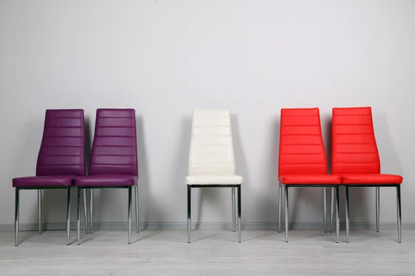 Modern color chairs on wall background — Stock Photo, Image