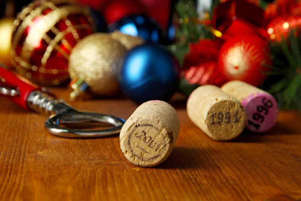 Wine corks with new Year toys on wooden table close-up — Stock Photo, Image