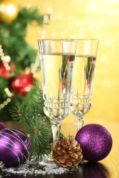 Composition with Christmas decorations and two champagne glasses, on bright background Stock Image