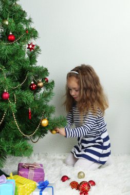 küçük kız odasında baubles ile Noel ağacı süsleme