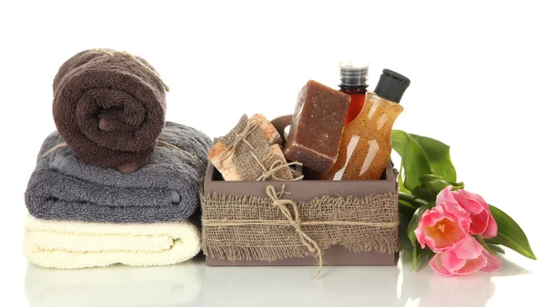 Composition of cosmetic bottles and soap in crate, isolated on white — Stock Photo, Image