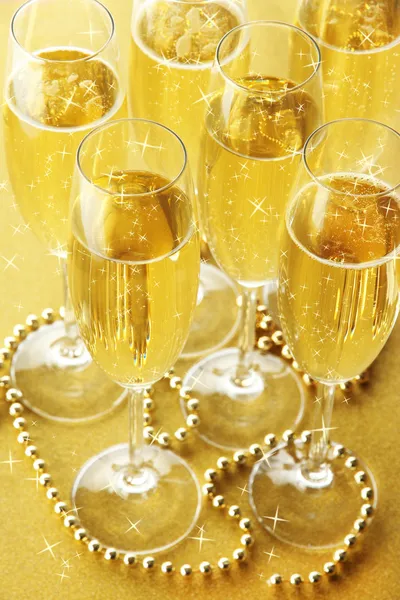 Glasses with champagne on shiny background — Stock Photo, Image