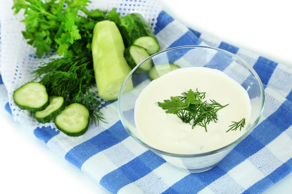 Cucumber yogurt in glass bowl, on color napkin, isolated on white — Stock Photo, Image