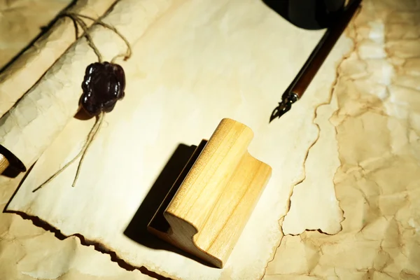 Wooden stamp and old papers, close up — Stock Photo, Image