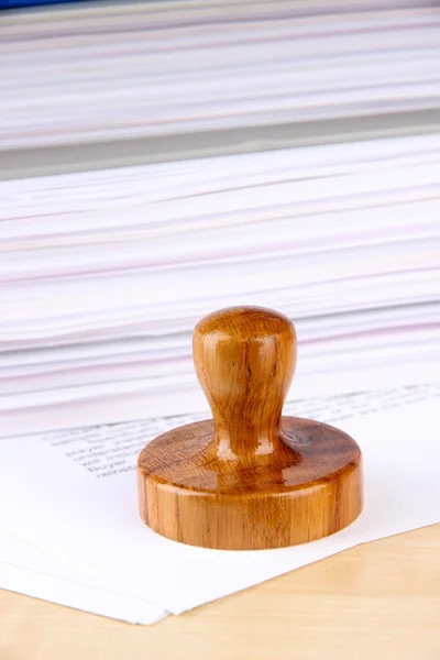 Wooden stamp and papers on table — Stock Photo, Image