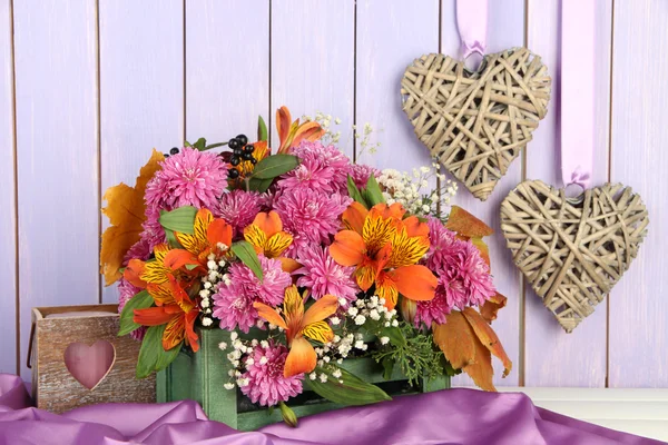 Composição de flores em caixa com decorações na mesa em fundo de madeira — Fotografia de Stock