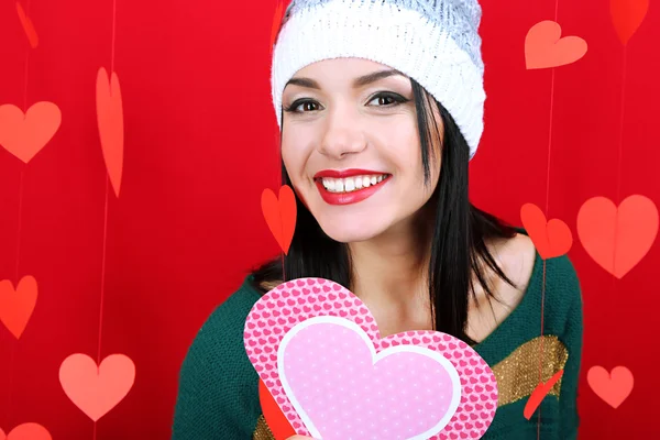 Attractive young woman with card on Valentine Day — Stock Photo, Image