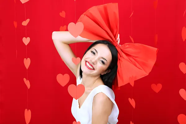 Attractive young woman with bow on Valentine Day — Stock Photo, Image