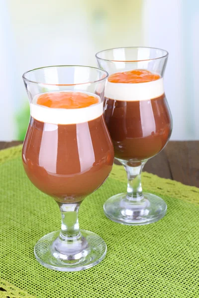 Dessert of chocolate and persimmon on table on light background — Stock Photo, Image