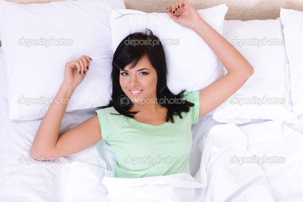 Beautiful young woman sleeping in bed