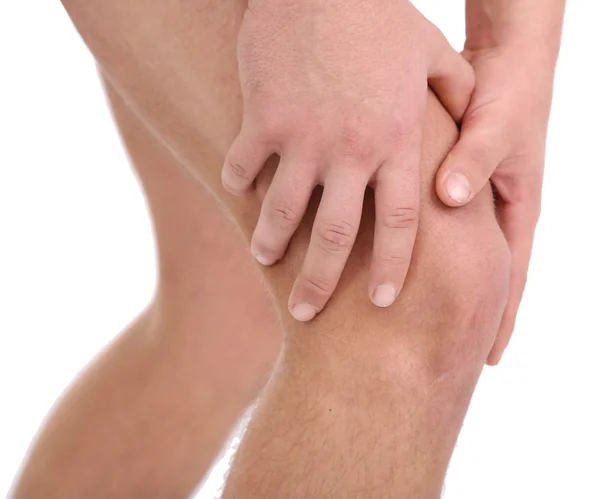 Hombre joven con dolor de rodilla, aislado en blanco — Foto de Stock