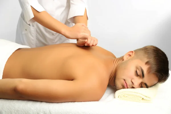 Young man having back massage close up — Stock Photo, Image