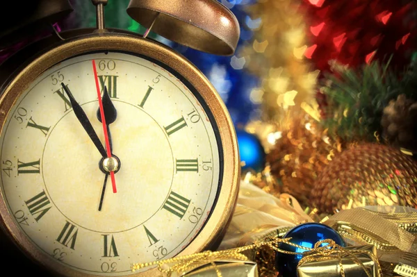 Composition of clock and christmas decorations on bright background — Stock Photo, Image