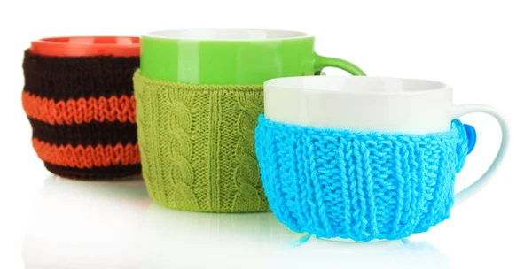 Cups with knitted things on it isolated on white — Stock Photo, Image