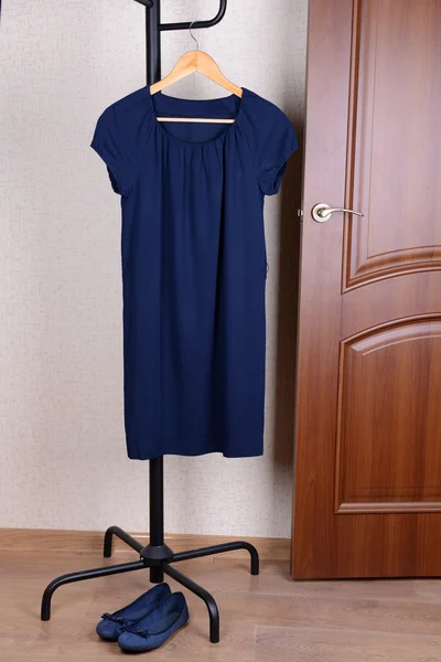 Dress hanging on hanger near door — Stock Photo, Image