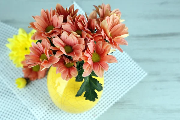 Beautiful flowers in vase, on wooden background — Stock Photo, Image