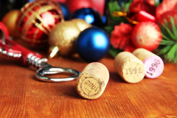 Wine corks with new Year toys on wooden table close-up — Stock Photo, Image