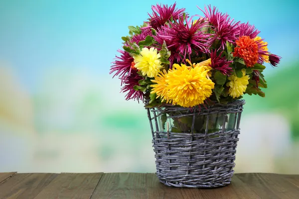 Composición con hermosas flores en canasta de mimbre s, sobre fondo brillante —  Fotos de Stock