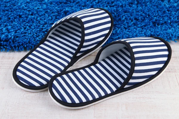 Striped slippers on floor background — Stock Photo, Image