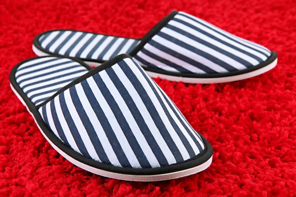 Striped slippers on carpet background — Stock Photo, Image