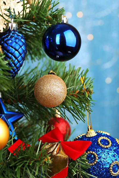 Toys on Christmas tree on Christmas lights background — Stock Photo, Image