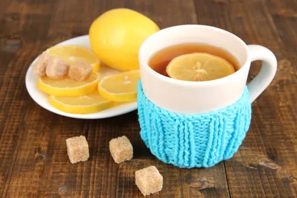 Tasse Tee mit Zitrone auf Holztisch — Stockfoto